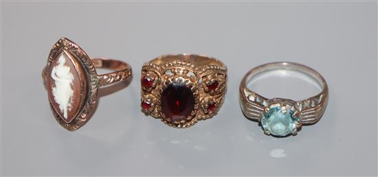 A 9ct gold and blue zircon ring and two other 9ct gold rings including a cameo ring.